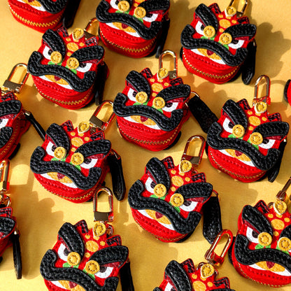 Collection of red and black decorative items resembling red and black lion dance guan yu head on a golden background